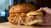 Papa Buck's BBQ's Pigzilla Challenge is 3 pounds of smoked, pulled pork covered in barbecue sauce and served on a giant 1lb. Hawaiian roll, as seen on Travel Channel's Man v. Food.