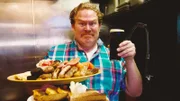 Host Casey Webb poses with the Flann O'Brien's Guinness Breakfast Challenge, as seen on Man v. Food.