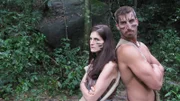 Lindsay Garrison and Matt Wright with their backs up against each other with war paint on their faces in Thailand.