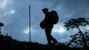 A member of the Expedition Unknown crew roaming the site of a possible Chupacabra attack in Barceloneta, Puerto Rico.