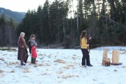 Snowbird Brown (r.) holds gun. Ami Brown (l.) and Rainy Brown (m.) standing by.