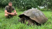 Forrest Galante With Galapagos Tortoise Kneeling Close Up.