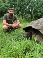 Forrest Galante With Galapagos Tortoise Kneeling Close Up.