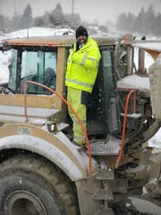 Casey morgan standing on the rock truck covered in snow