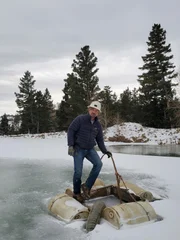 Dave turin standing on the frozen cage as the team had to release the suction hose to free it from ice