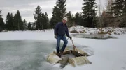 Dave turin standing on the frozen cage as the team had to release the suction hose to free it from ice