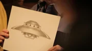 Heavenís Gate member holds UFO photo.