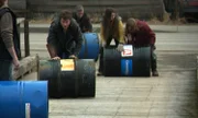 Matthew, Gabriel, Snowbird, Bear and Bam Bam Brown rolling fuel drums on dock.