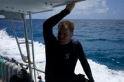 Josh puts on scuba gear as he prepares to dive to shipwrecks in the Bermuda Triangle.