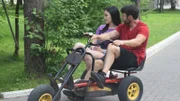 GEOFFREY AND VARYA riding a bike.