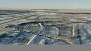 The front of Ted Stevens Anchorage Airport  showing the parking lots and surroundings