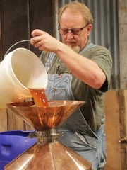 Digger pouring into his still