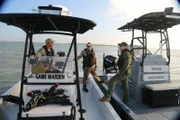 Texas Game Wardens Colby Hensz and Shane Horrocks consulting with another warden.