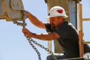 Dave Turin securing equipment with chains.