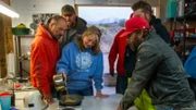 Dave Turin, Nathan Clark, Jason Sanchez, Casey Morgan and Chris Taylor watch closely as Shelly Turin weighs the gold from the first Hummocks clean up