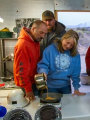 Dave Turin, Nathan Clark, Jason Sanchez, Casey Morgan and Chris Taylor watch closely as Shelly Turin weighs the gold from the first Hummocks clean up