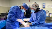 Dr. Brad performing surgery with crew
