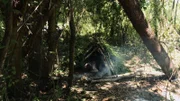 Michelle and Jeremy lying in their shelter.