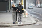 Young Woman Assisting Blind Man With White Stick On Street