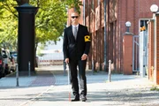 Blind Man Walking On Sidewalk Holding Stick Wearing Armband
