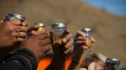 Close up - Everyone raises their jars of gold in tribute to & memory of Comrade/Husband Jesse Goins