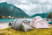 Camping tents on the coast of the alpine lake in Bayern (Bavaria), Germany.