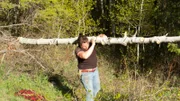 Gabe Brown cuts down tree to create wedding ceremony arch.