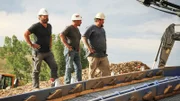 Hands on hips next to the sluice box. L-R: Chris Taylor, Dave Turin and Nathan Clark.