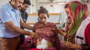 ANANTNAG, KASHMIR - JULY 05: Doctor Malik Azad checks Khalida Akhter, 18, after the surgery at the Mirza Mohd. Afzal Beigh Memorial Hospital or Government District Hospital on July 05, 2015 in Anantnag, Kashmir.  Doctors in Kashmir claim to have removed the world's biggest cyst - weighing a massive 48.5 lbs. The giant cyst, which weighed more than a five-year-old child, was removed from an 18-year-old patient Khalida Akhtar. Doctors removed the growth from the teenager’s ovary after Khalida arrived at the hospital complaining of discomfort and a severe abdominal pain.  PHOTOGRAPH BY Shams Ul haq Qari / Barcroft India