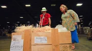Sally and Laurence with a wooden crate won for a $1,700 win. The crate contains a bag of precious stones. An appraisal in Manhattan's Diamond District proves they are valuable, natural gems. The Martins head home with a hefty $3,580 overall profit.