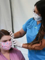 Dr. Lee examines Lattyse in the Covid tent.