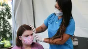 Dr. Lee examines Lattyse in the Covid tent.