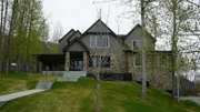 The front of Bear Ridge house has a long walkway with multiple stairs to the front door with a sliding door on the left, for Ashleigh and Ashley's house search, in Anchorage, Alaska, as seen on Great American Country's Living Alaska.