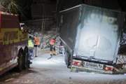 Overhalla, Norway - The truck that is stuck in the ditch and has problems on a slippery road is attached to a wire that is connected to the towing truck.   (photo credit: National Geographic)