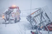 Overhalla, Norway - Total of truck that has tipped over. The truck in the ditch is attached to a wire that is connected to the towing truck. This is one of the elements that will help the truck up from the ditch. They are also using air-pillows to help it.