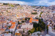 Aerial footage of the Basilica of the Annunciation over the old city houses of Nazareth