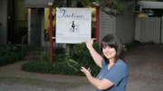 Owner Cara stands outside of her restaurant, Tartine, in New Orleans, Louisiana, as seen on Food Network's Mystery Diners, Season 9.