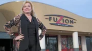 Keeli, owner of Fuzion in Huntington Beach, California, stands outside of her restaurant, as seen on Food Network's Mystery Diners, Season 9.