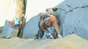 A man climbing on a cliff.