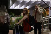 Outside the hotel, Colt and Jess wait as Jess prepares to leave.