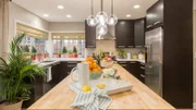 The kitchen of the Pham's newly renovated home in Huntington Beach, California. Designer Jasmine Roth's renovations include an extended kitchen and a Not So Lazy Susan cut in the island's butcher block, as seen on Hidden Potential.