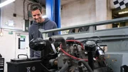 Marc (Elvis) Priestley works on the Landrover in the garage.