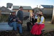 Josh Gates has a pow-wow with Brien Foerster, Gustavo Morales, and the Uros island locals.