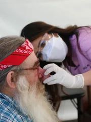 Dr. Lee examines Terry’s nose in the covid tent.