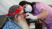 Dr. Lee examines Terry’s nose in the covid tent.