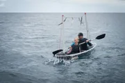 Ian Ziering and Tara Reid kayak in the ocean.