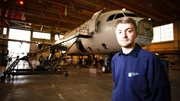 contributor in Hangar with plane in background