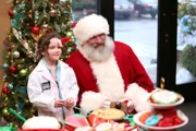 Santa poses with a tiny doctor fresh out of medical school.