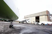 eCube Solutions logo in Hangar wall, planes outside on plane yard floor