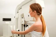 A young woman taking a mammogram x-ray test
